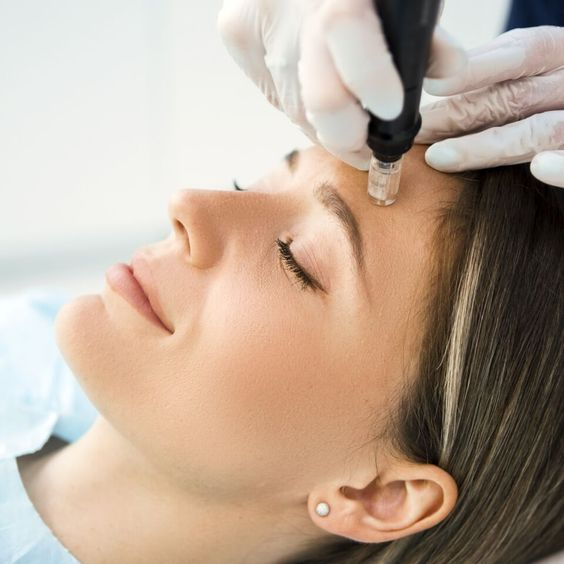 a woman getting a facial treatment