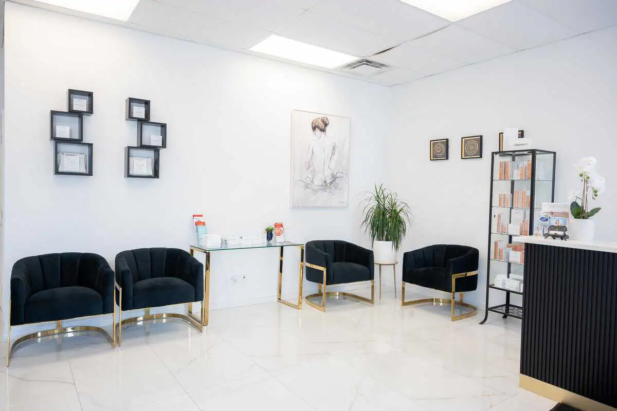 a room with black chairs and a white wall