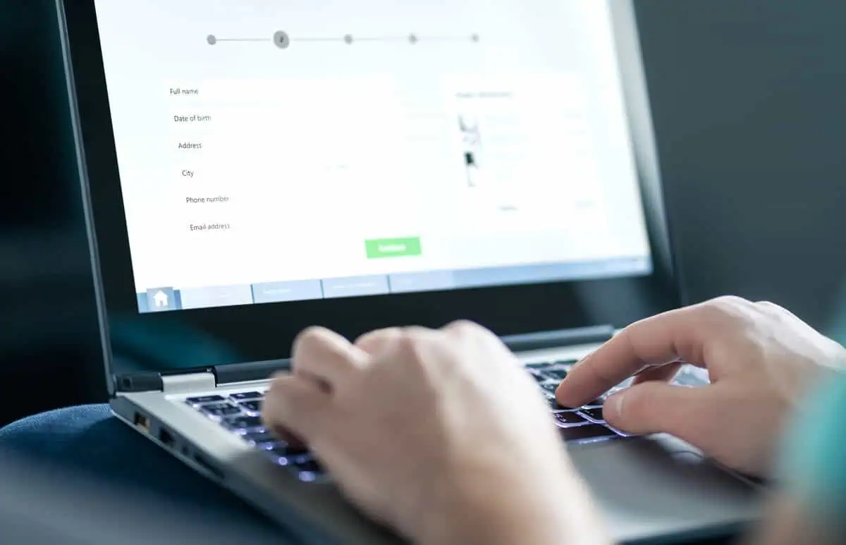 a person typing on a laptop